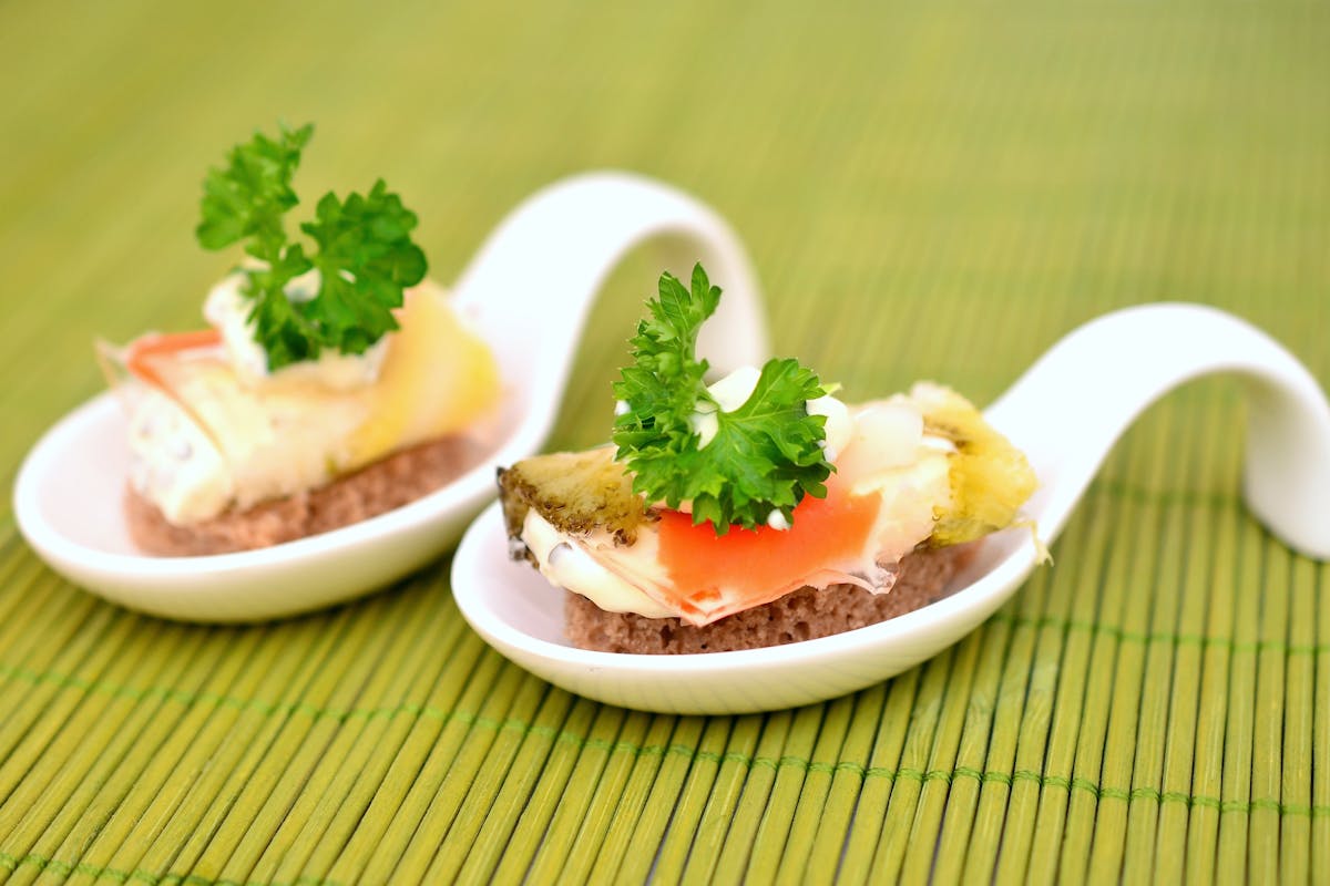 A couple of spoons with some food on them