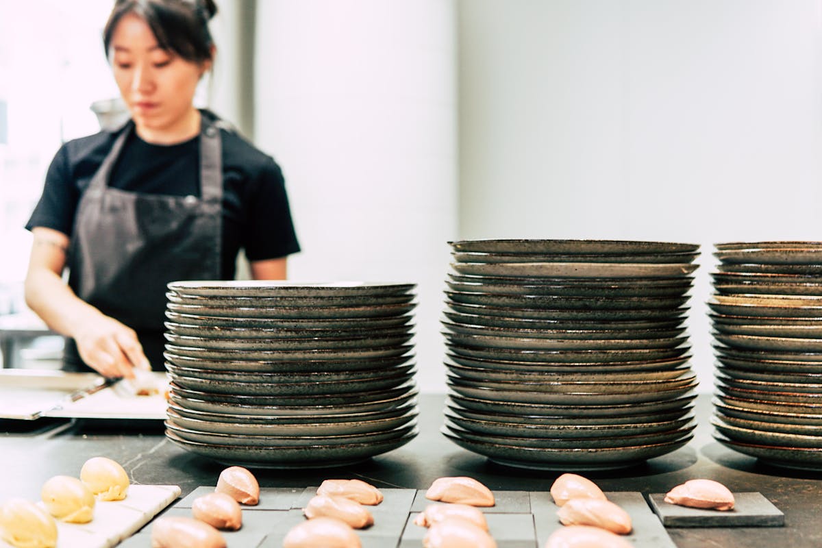 A chef creating plates of food for a client