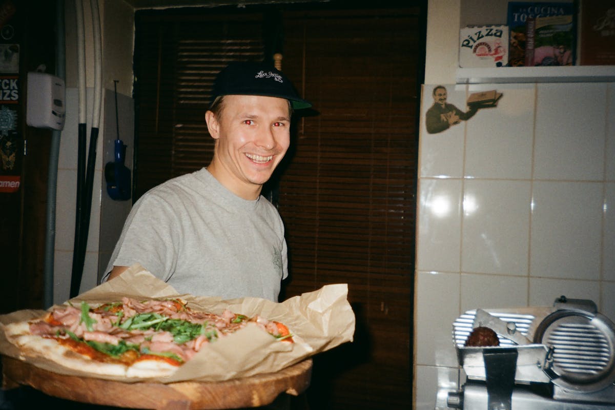 A chef showing a pizza to the camera