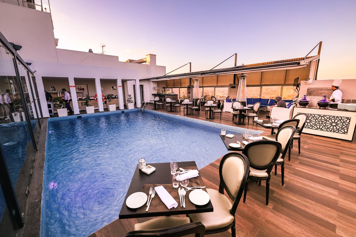 A pool with a bunch of tables around it