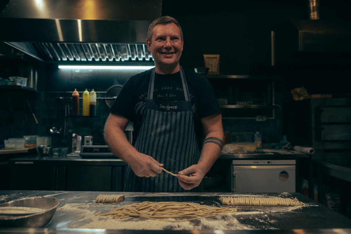 A private chef standing in front of a table
