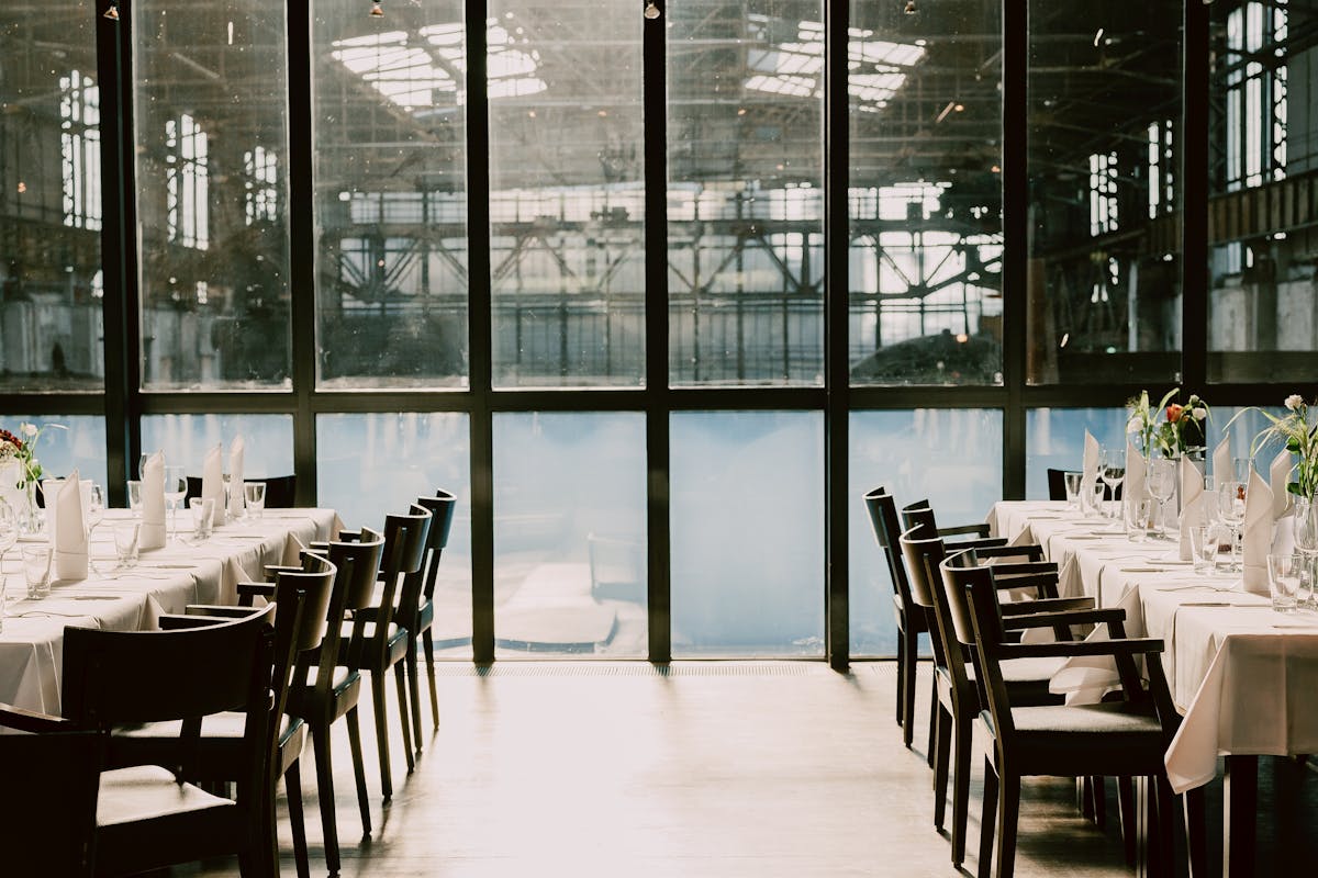 A room with tables and chairs set up for a corporate event