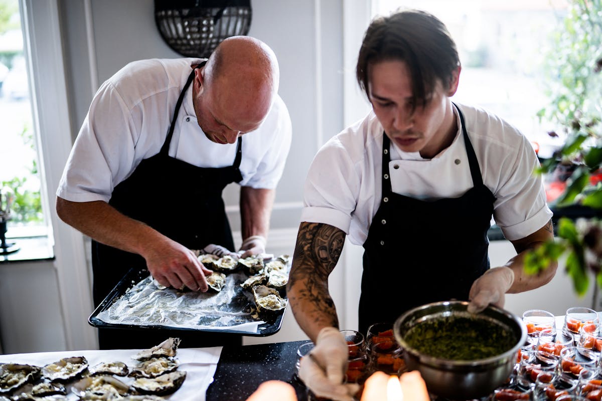 Multiple chefs creating plates for a corporate event