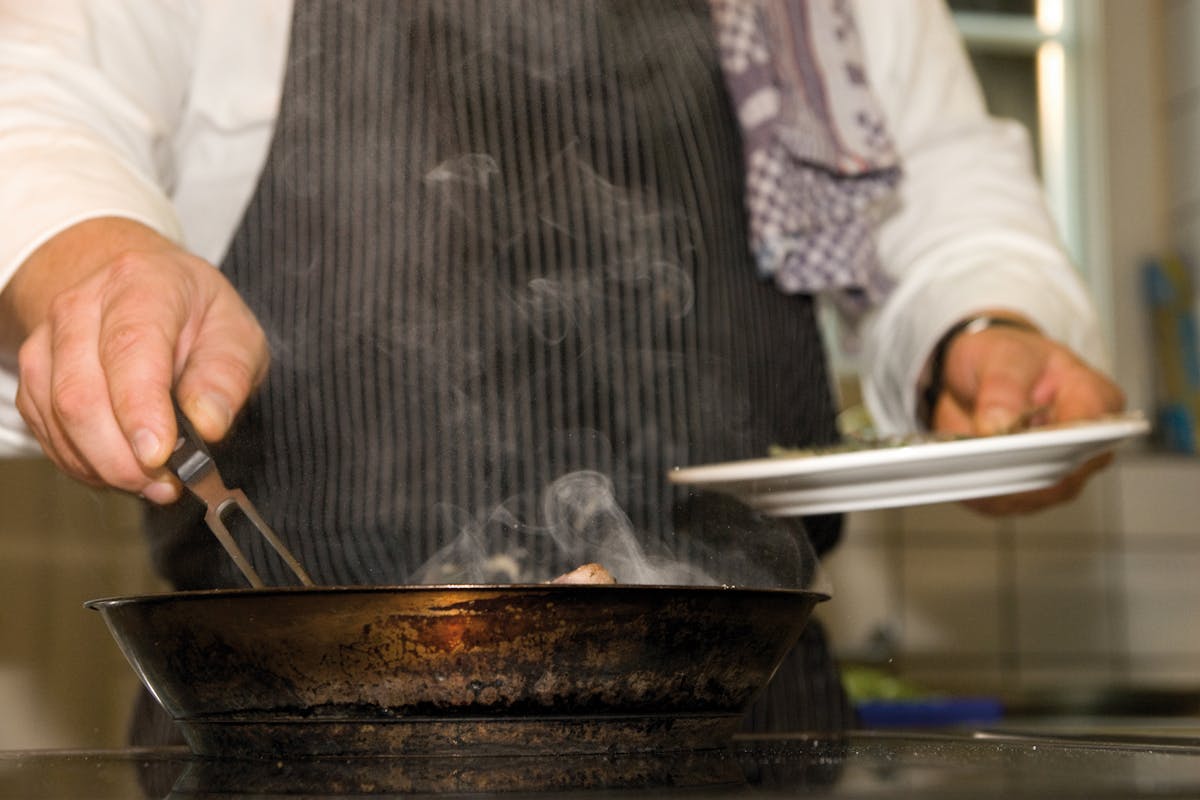 A private chef making up a plate of food or a client