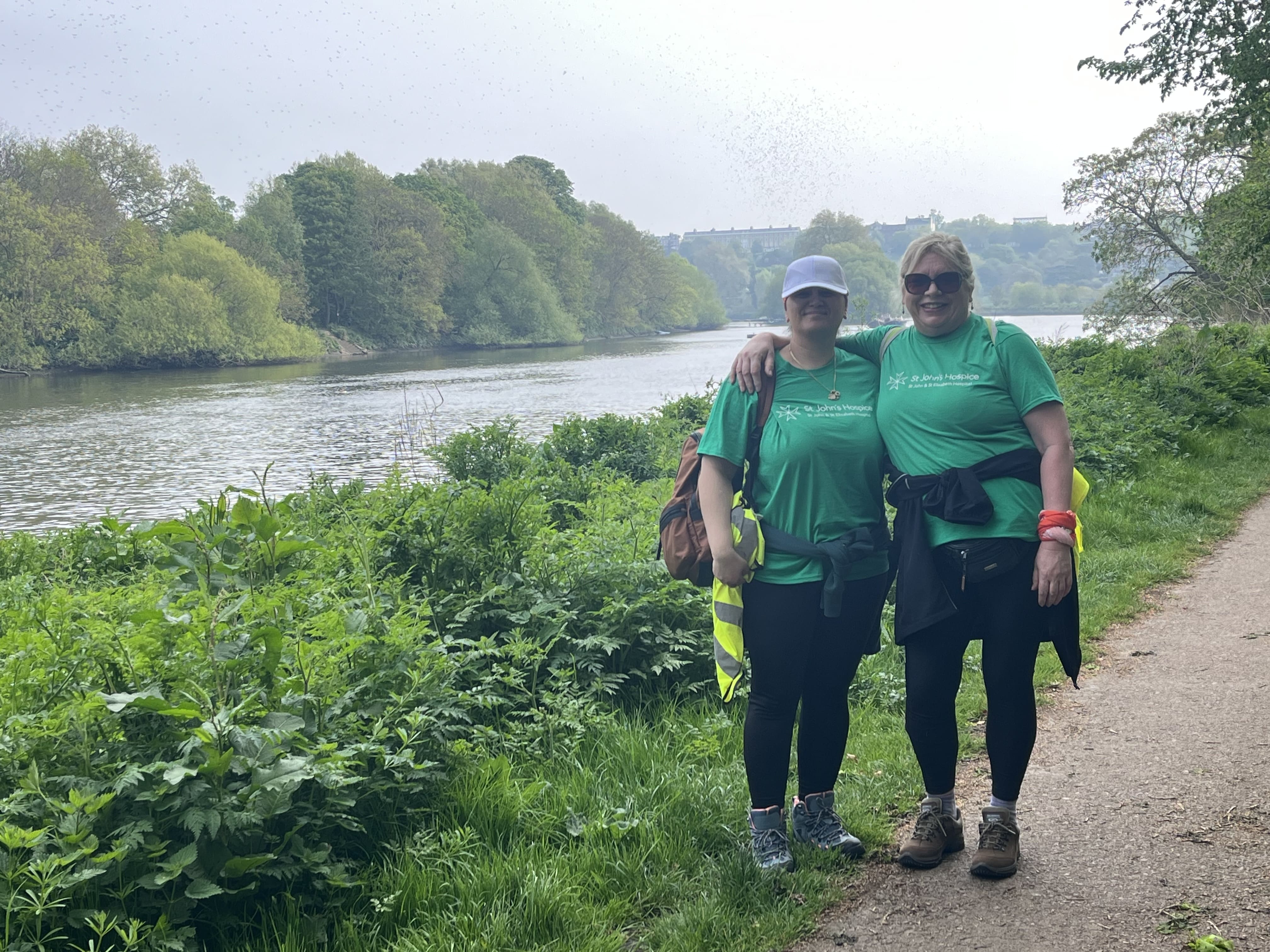 Two fundraisers pose along the Thames Footpath while completing the challenge.
