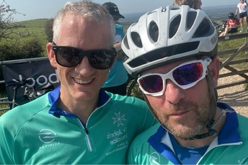 A close up view of a cyclists bike riding on the streets of Paris, with the Eiffel Tower in the distance.