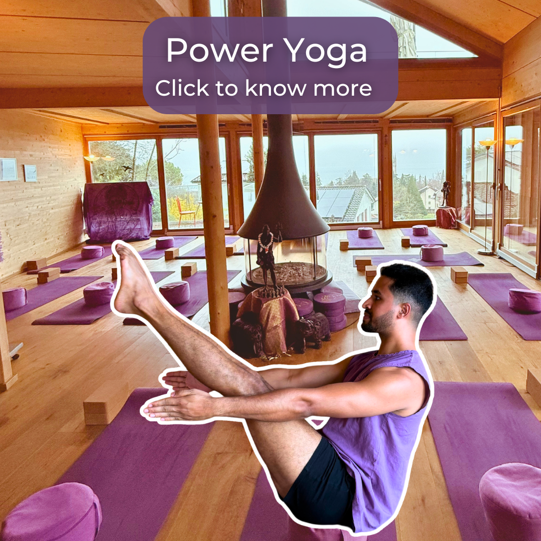 Man in a purple tank top doing a boat pose on a purple yoga mat in a spacious wooden studio.