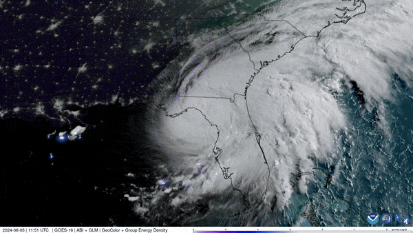 Nighttime satellite image showing hurricane system with well-defined spiral structure making landfall on southeastern United States coastline with visible city lights
