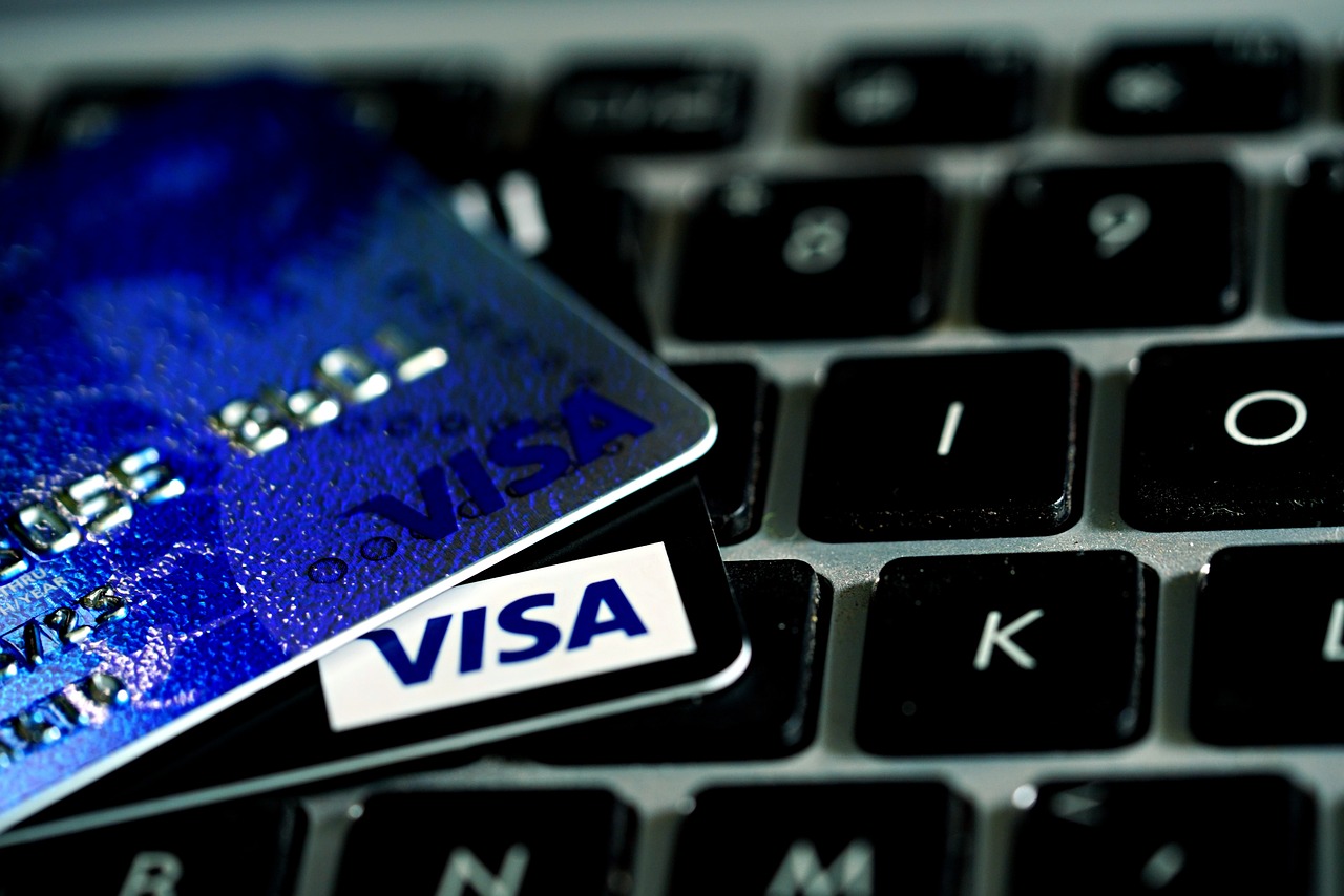 A close-up image of two payment cards placed on a laptop keyboard