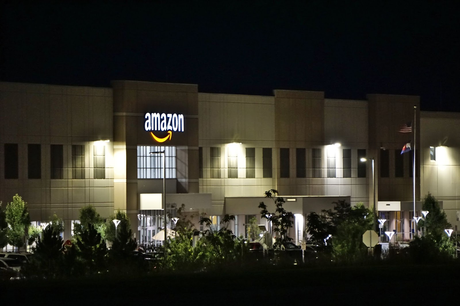 A nighttime photo of an Amazon building