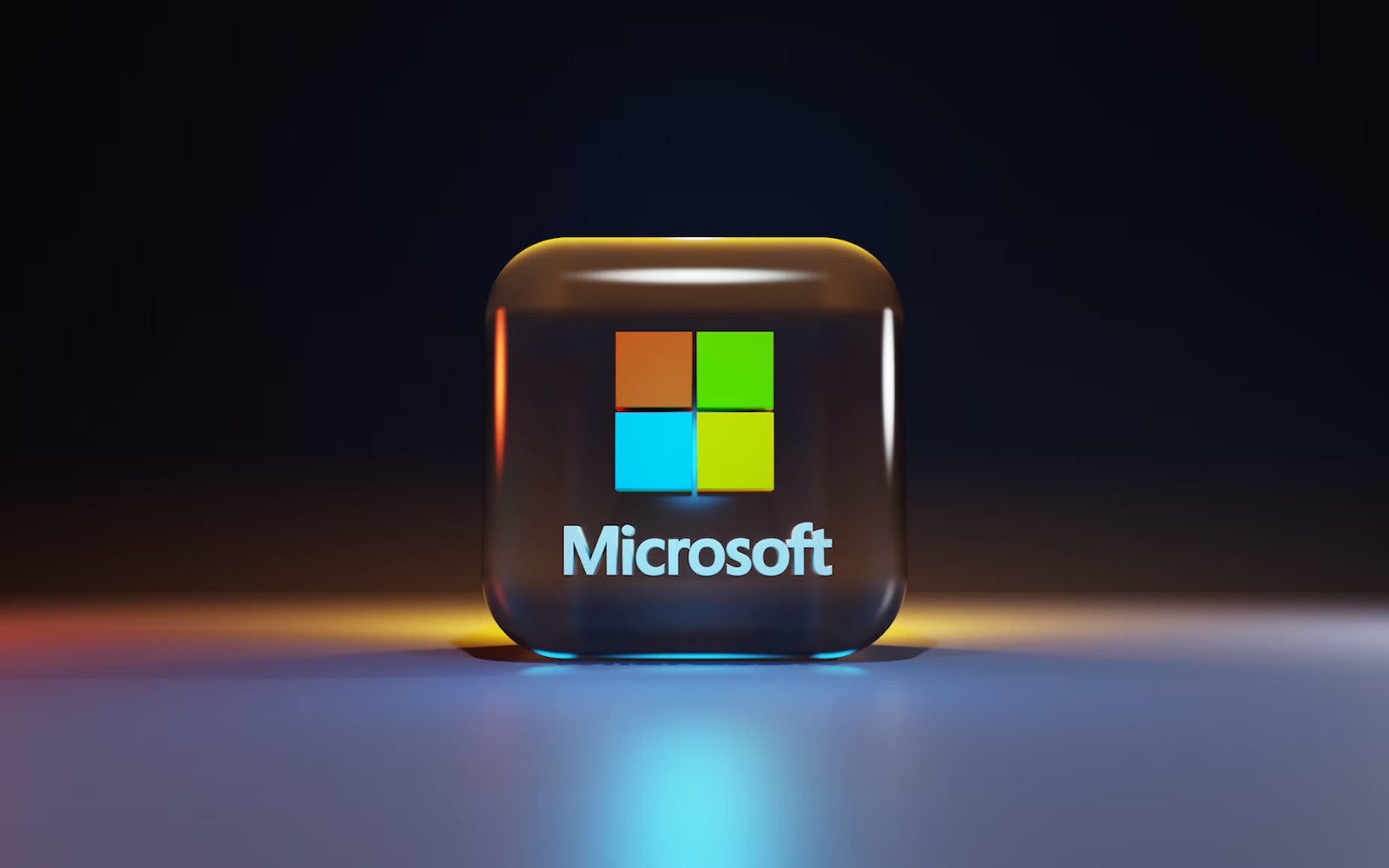 A 3D render of a glass cube with the Microsoft logo on it