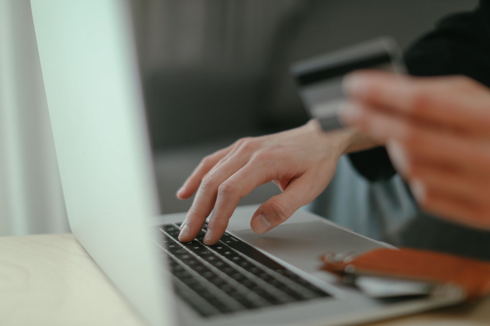 A photo of a person making an online purchase on a laptop