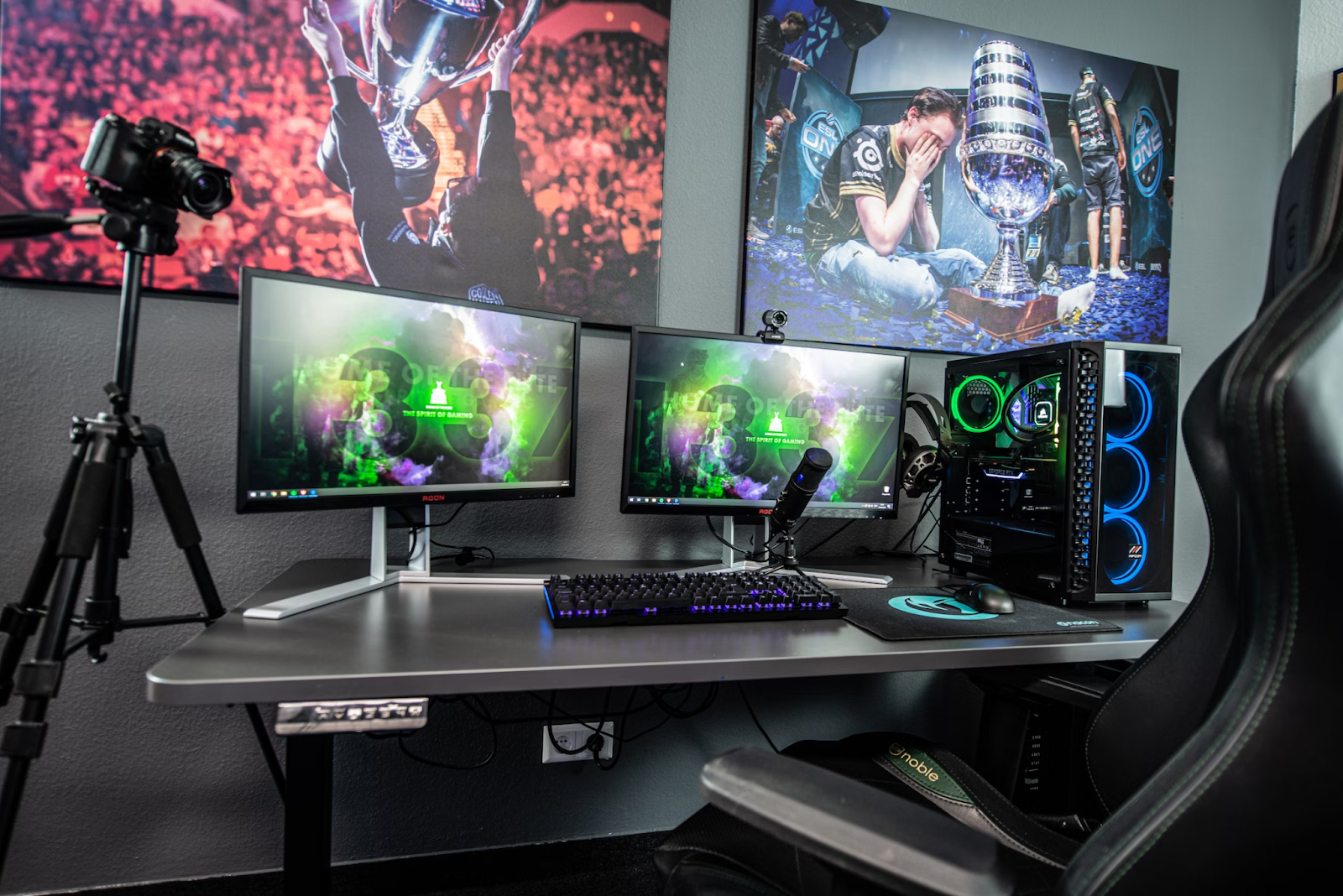 A photo of a gaming setup with two monitors, a streaming camera, and a microphone