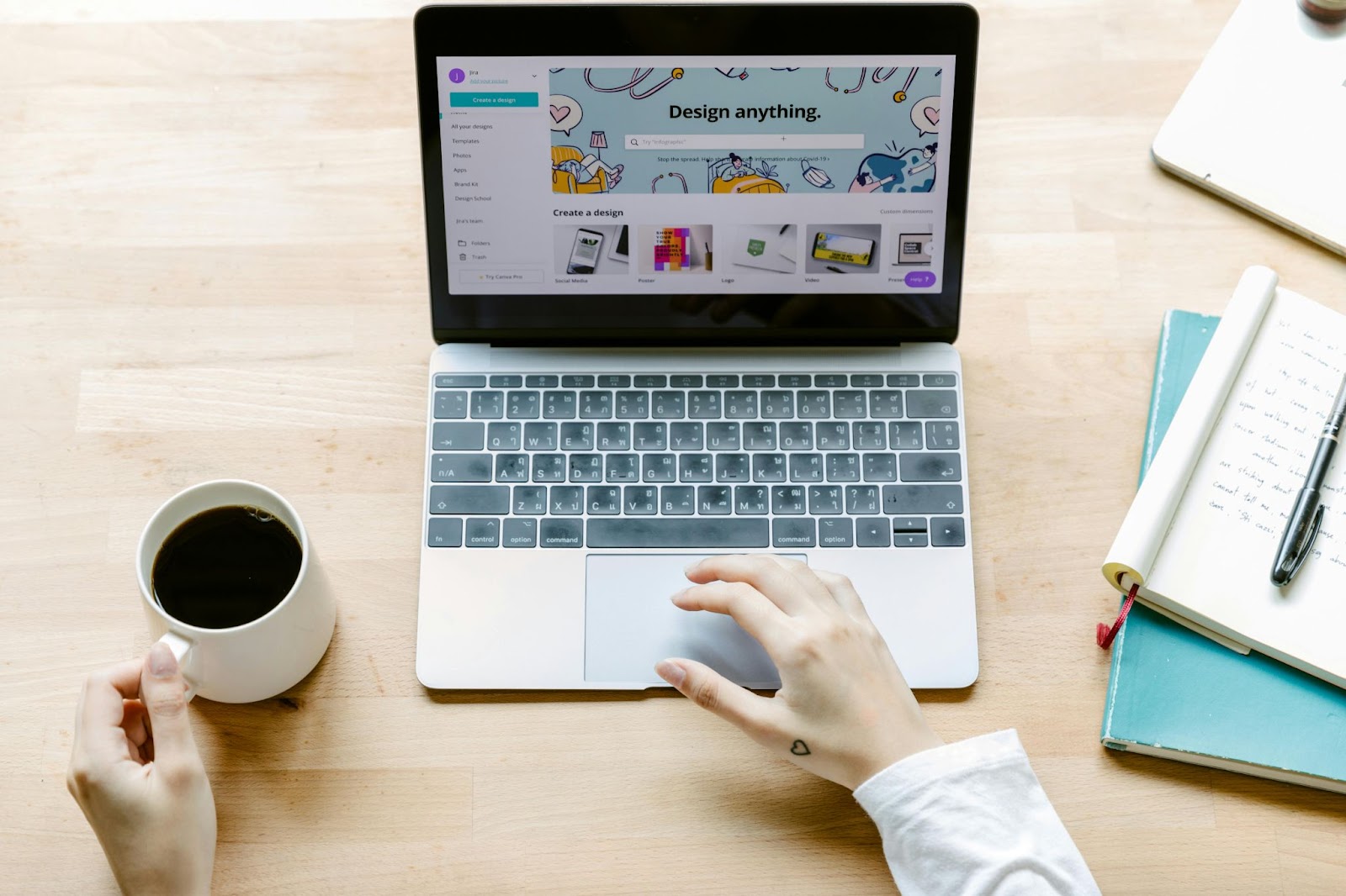 A bird’s eye view photo of a person using Canva on a laptop