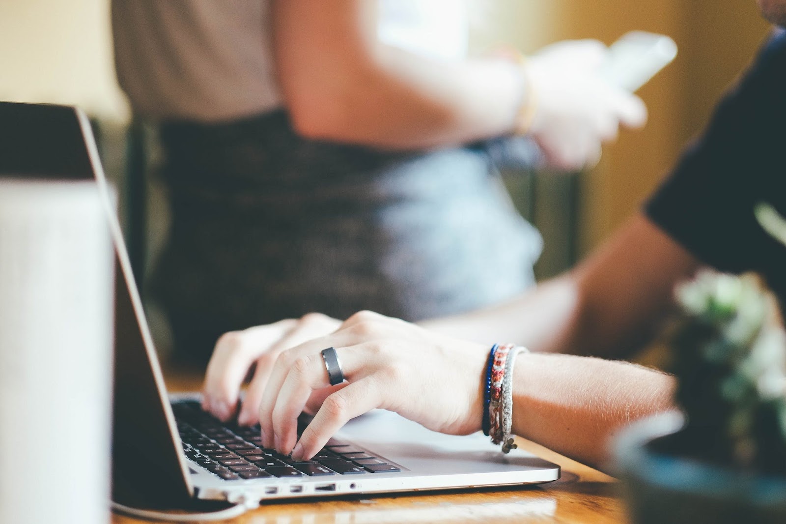 A photo of a person typing on a laptop keyboard