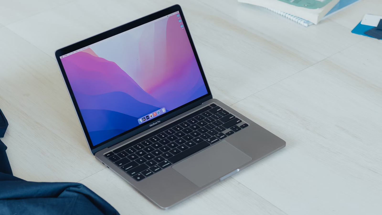 A photo of a MacBook Pro placed on a wooden table