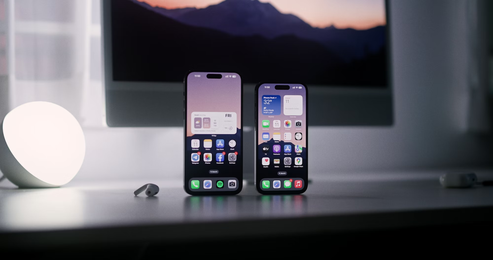 A photo of two iPhones standing upright on a table