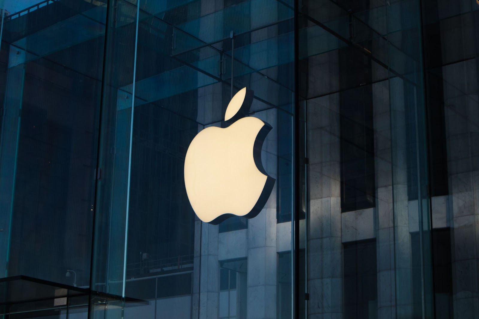 A photo of Apple’s logo on a glass building