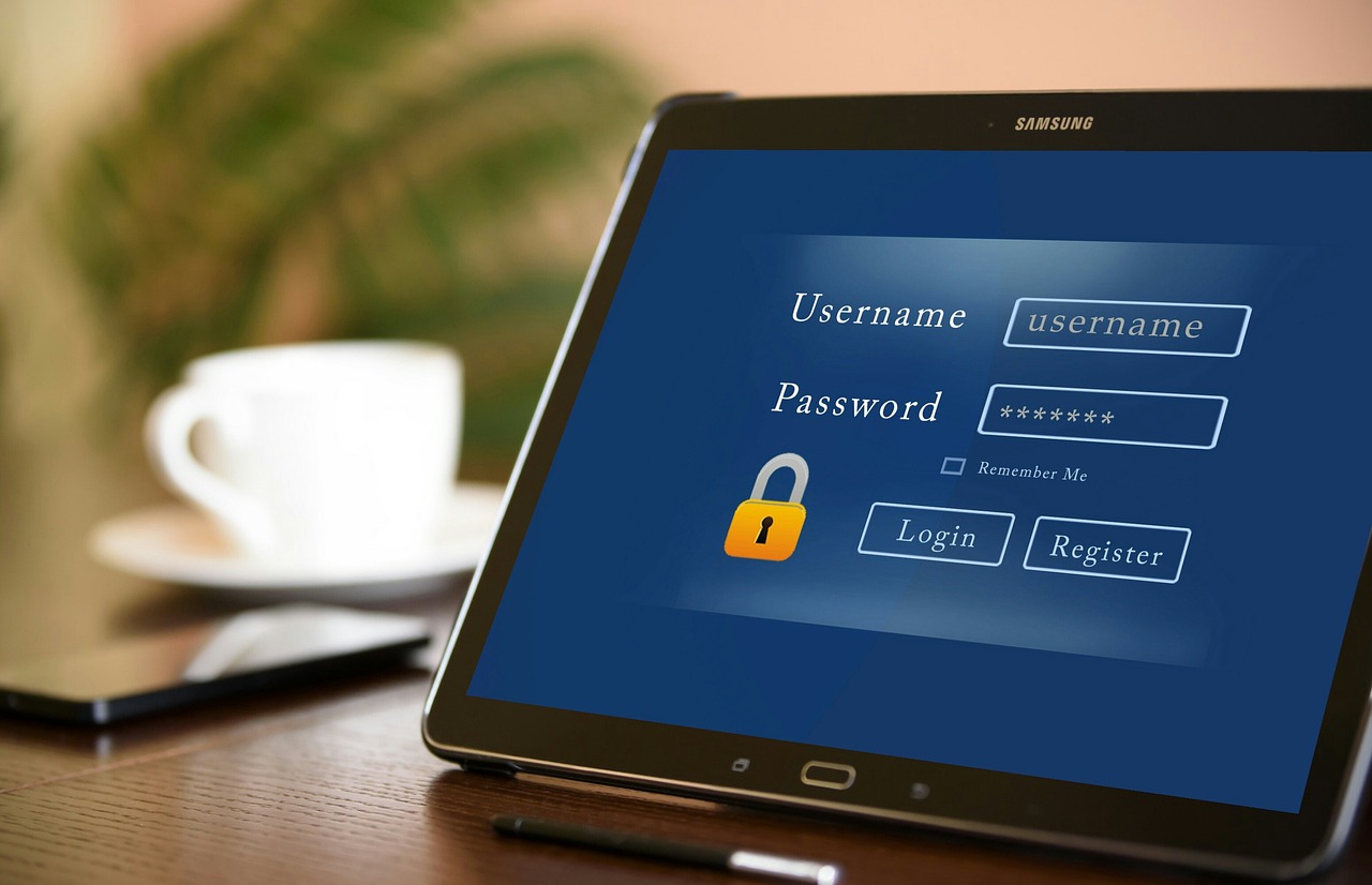 A photo of a tablet displaying a blue login screen with fields for username and password