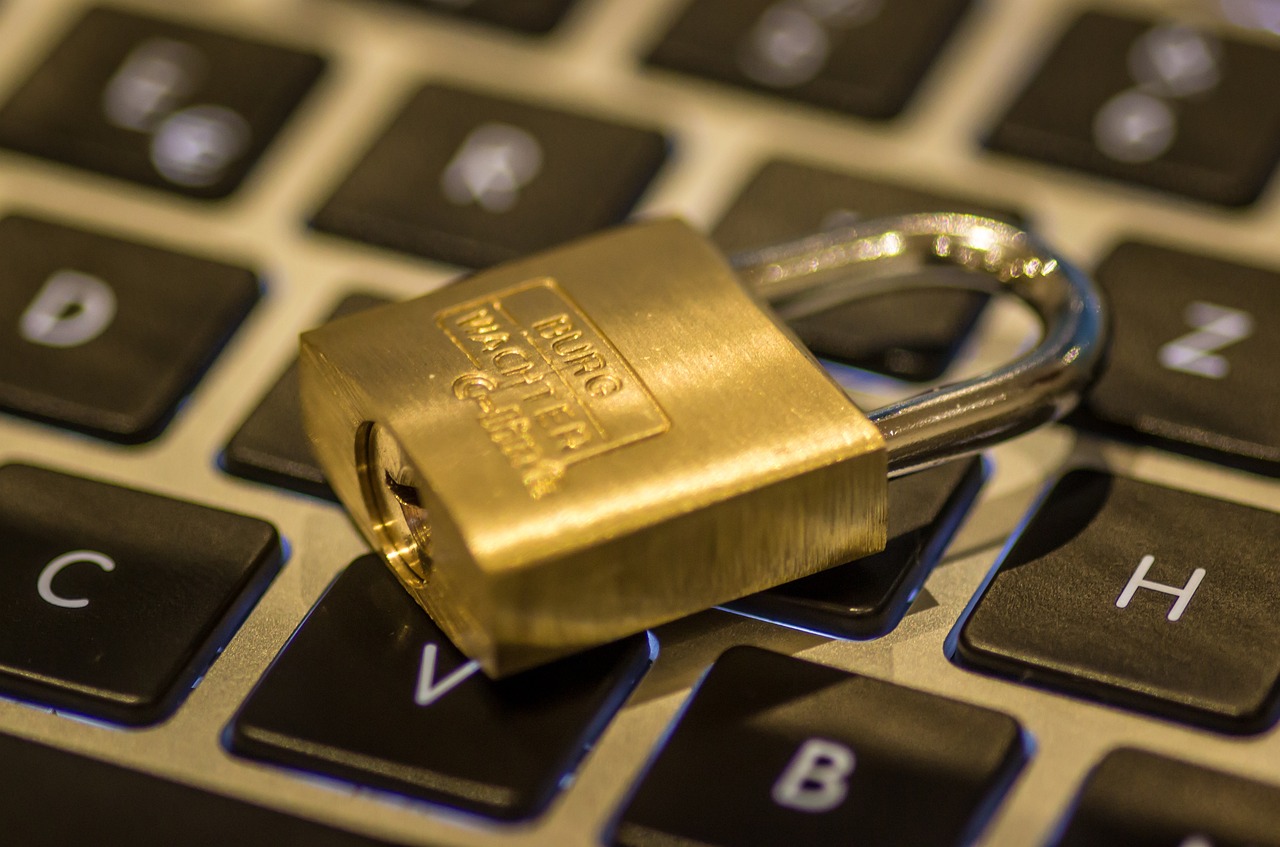 A close-up photo of a brass padlock placed on a laptop keyboard