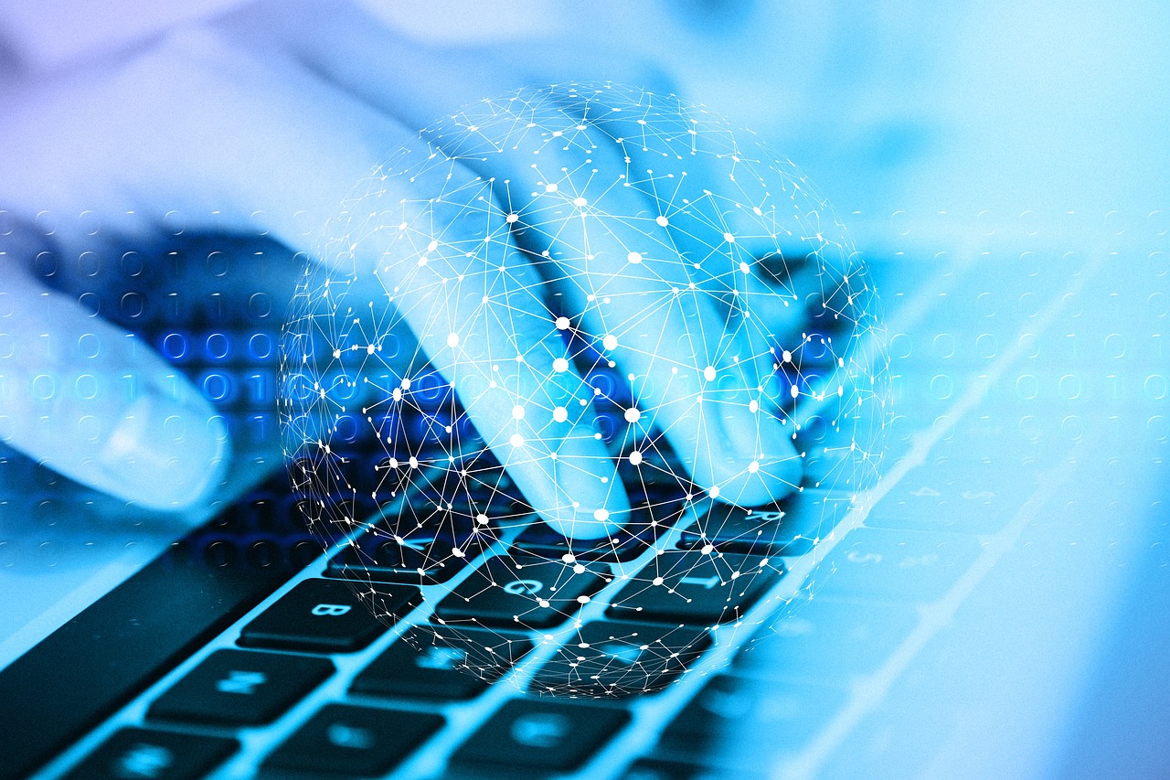 A blue-tinted close-up image of a hand typing on a keyboard, overlaid with a digital network globe