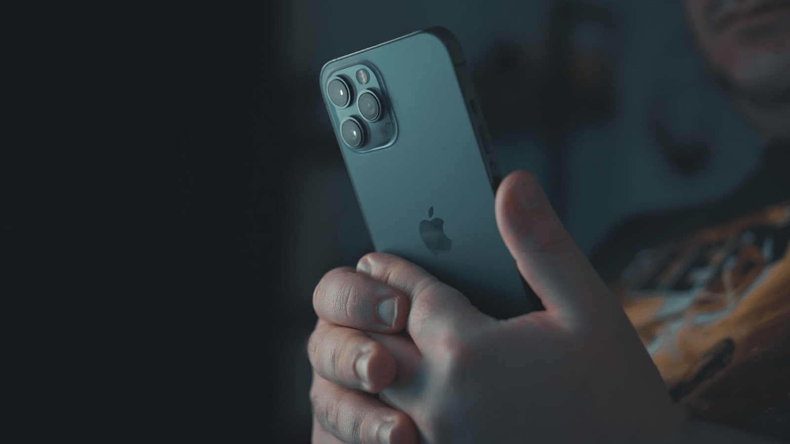 A close-up photo of a person using an iPhone with both hands