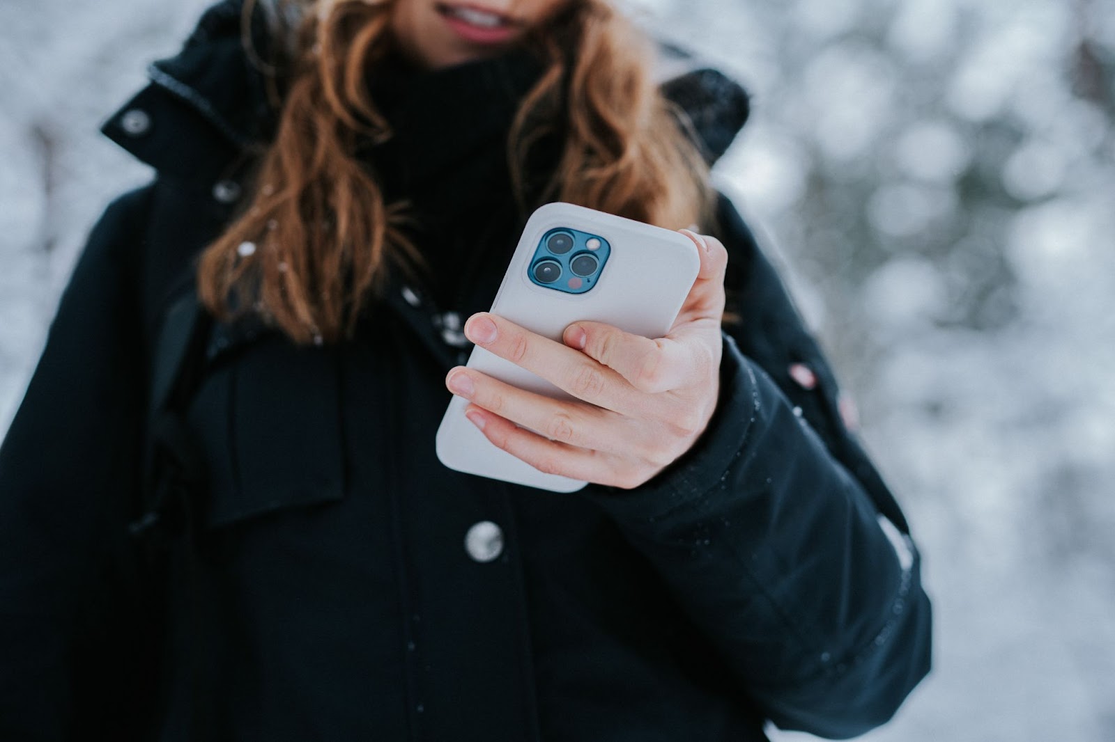 A photo of a person using an iPhone with one hand