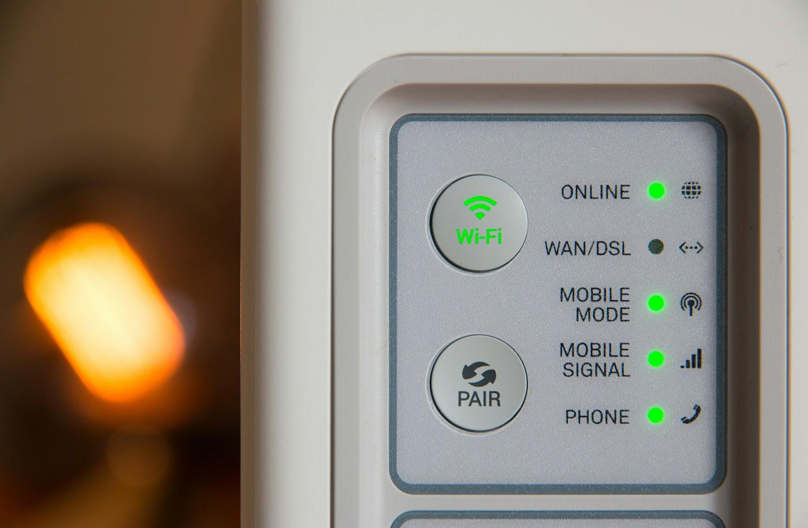 A close-up photo of a network router interface panel showing active connections with green status lights