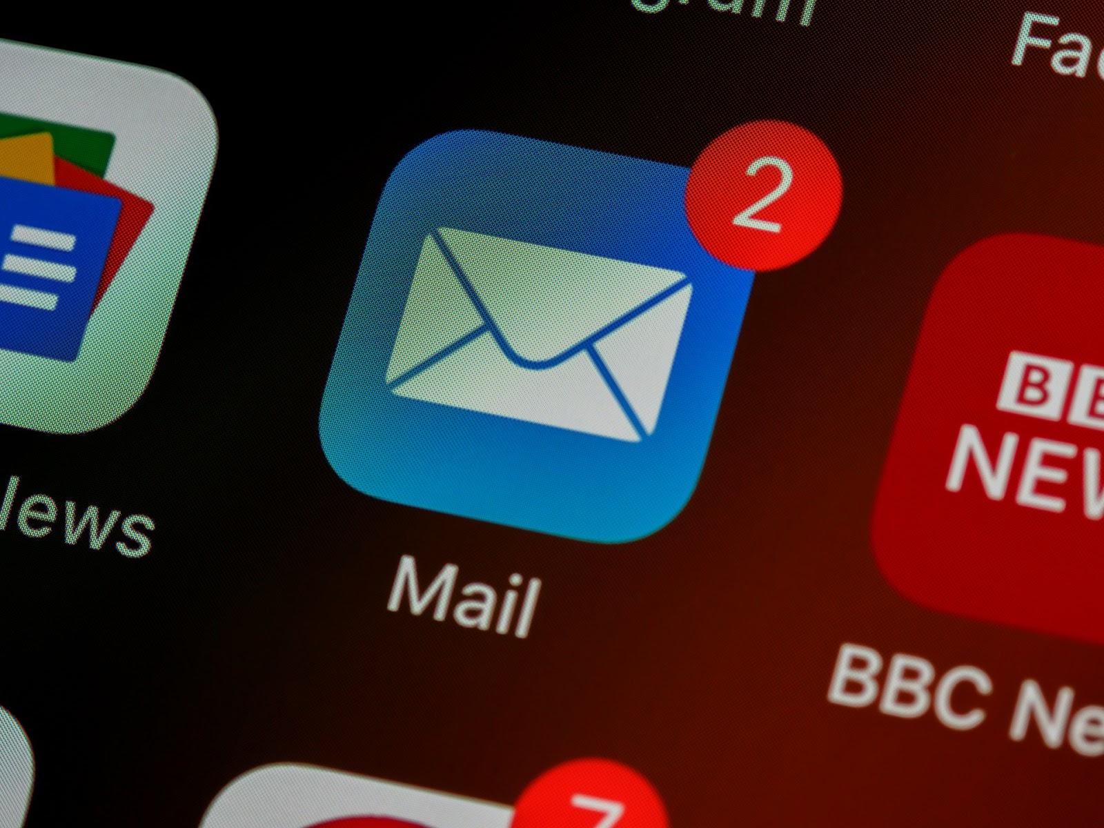 A close-up shot of a smartphone screen showing a blue Mail app icon with two unread message notifications