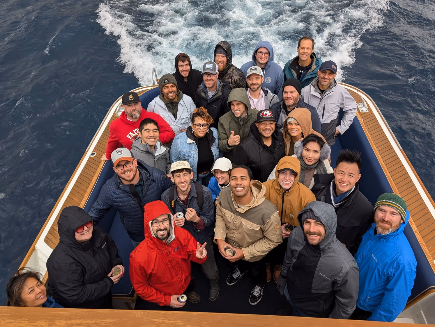 A group photo of the employees of TEECOM on a boat