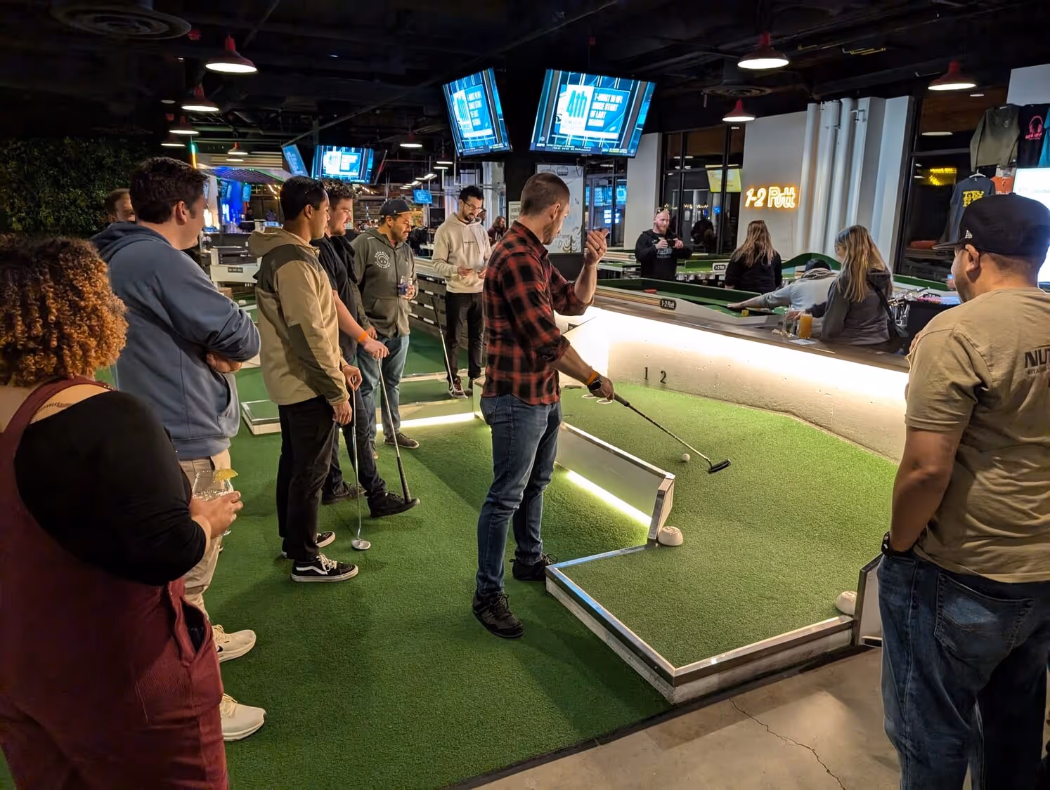 A candid photo of a TEECOM group outing at mini golf