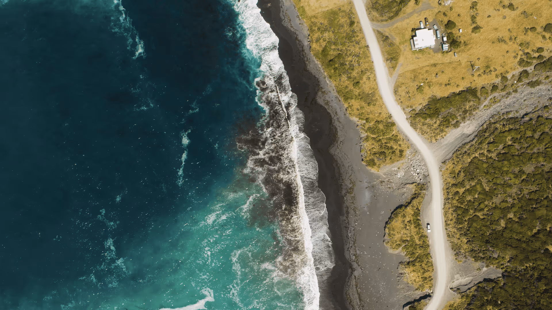 An aerial view of a beach and a house.