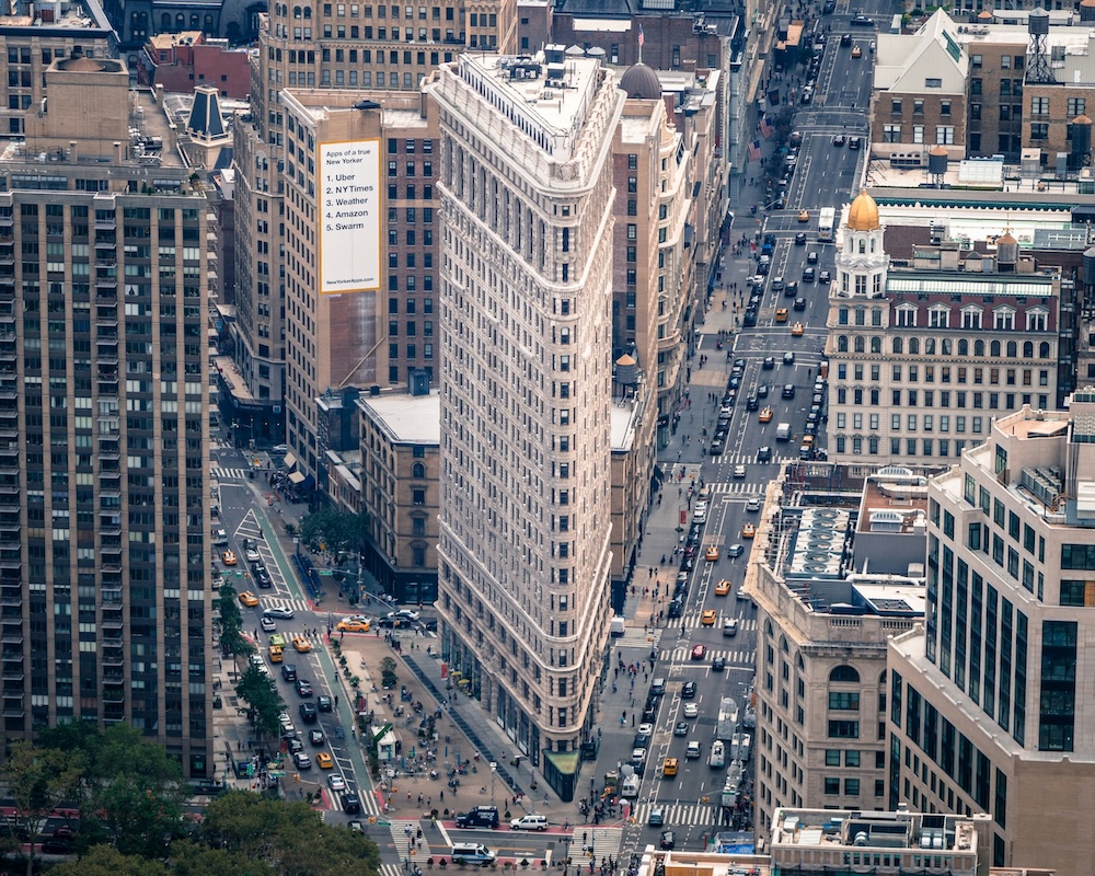 Aerial view of Flatiron Building in New York City with busy streets