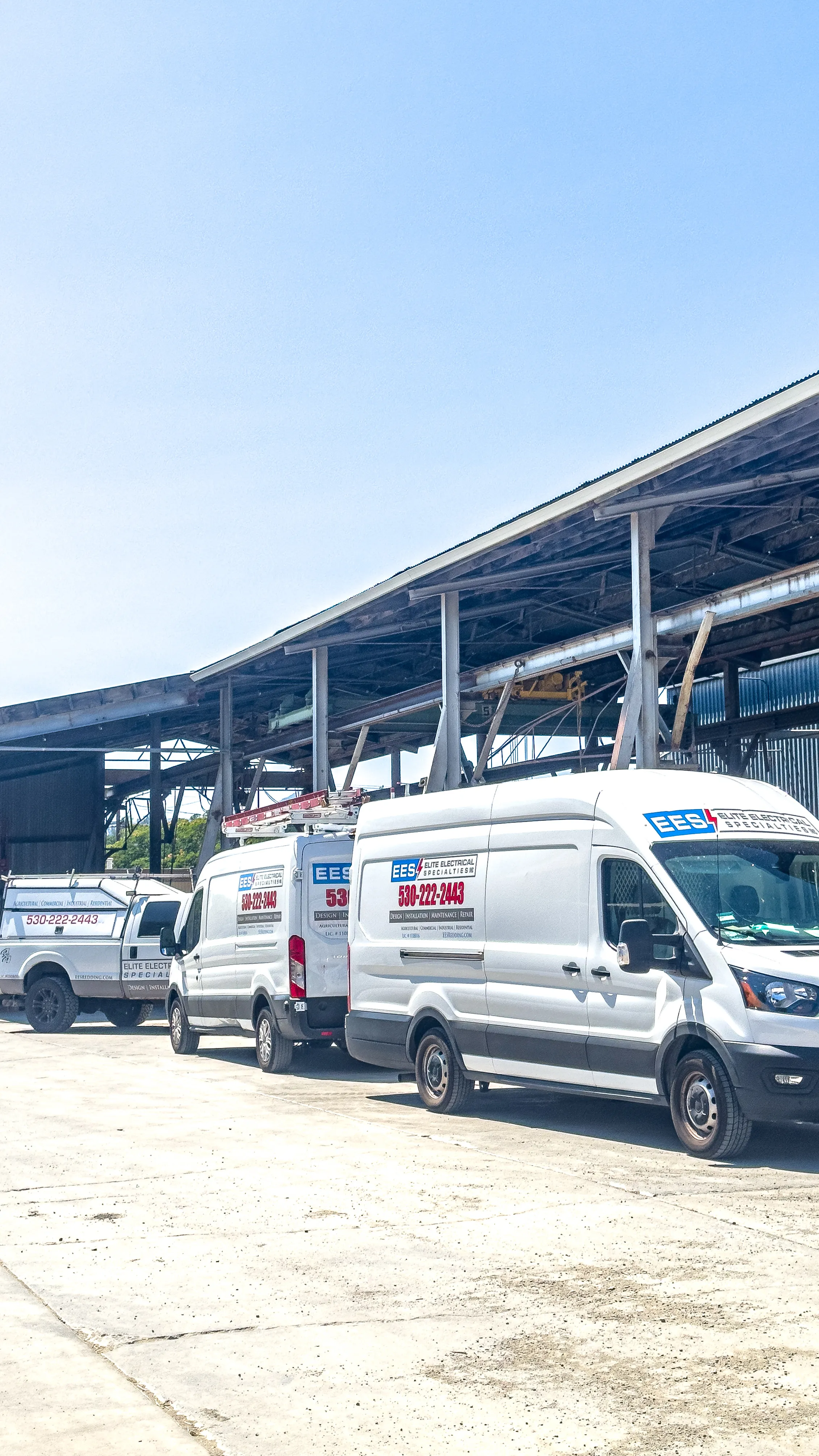Elite Electrical service vehicles staged at the Oldcastle Infrastructure industrial facility in Redding.