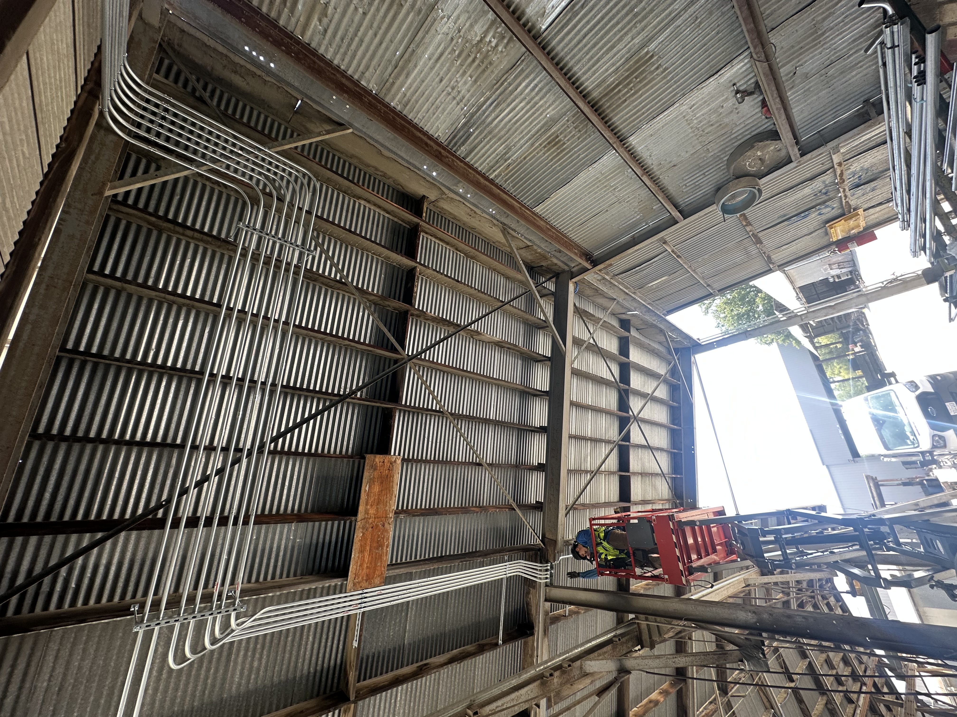 Completed overhead conduit and raceway retrofit inside the Oldcastle Infrastructure facility in Redding.