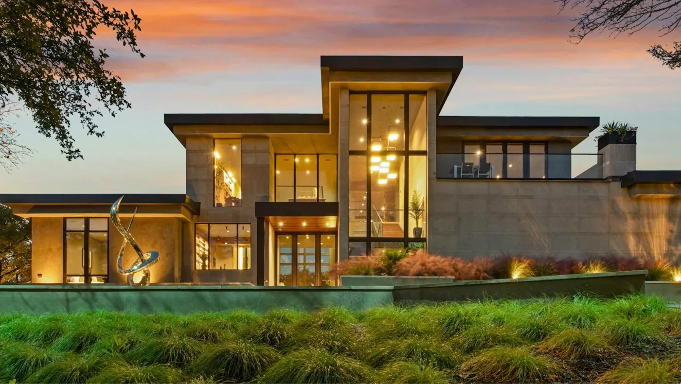 High-end modern residence illuminated at dusk.