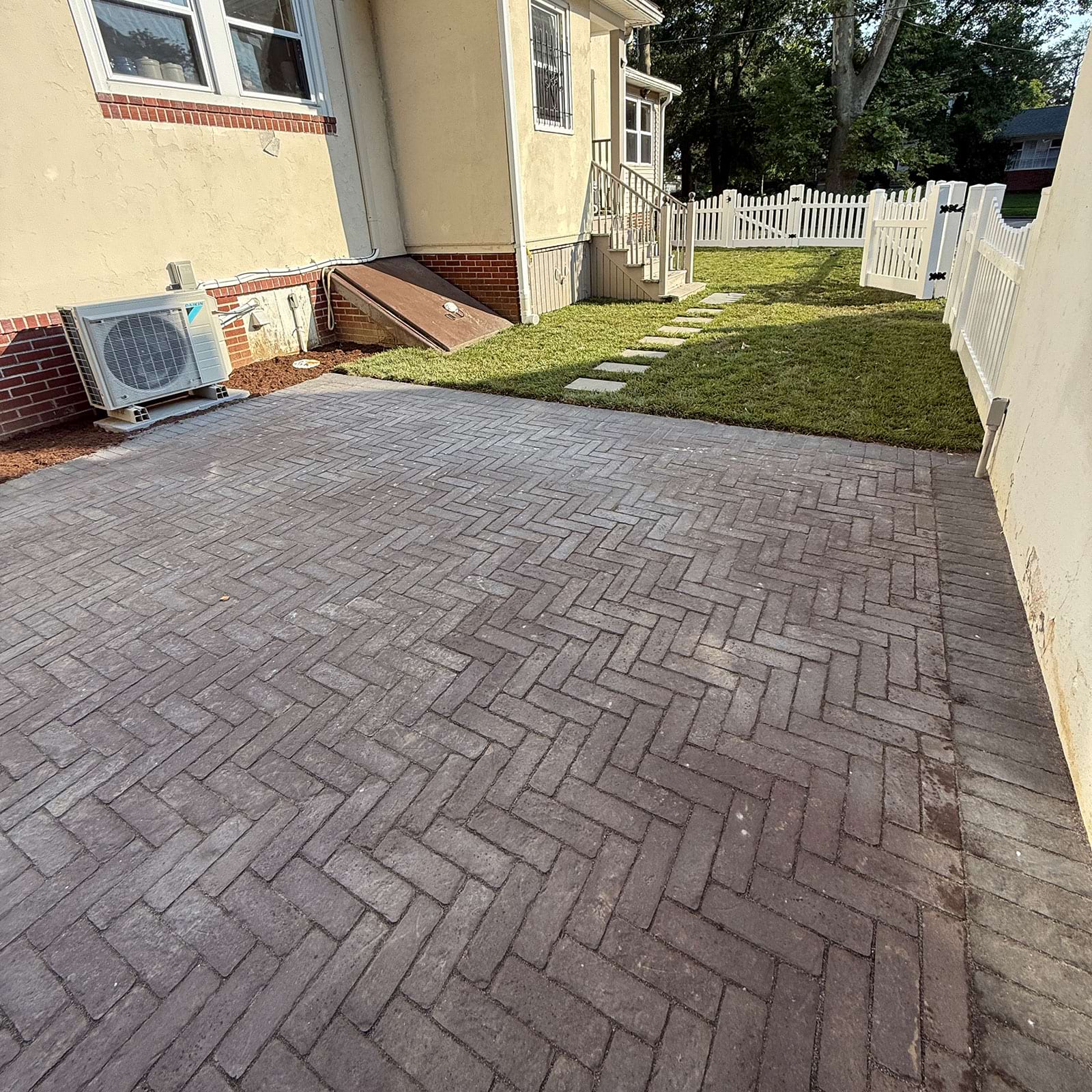 Brick walkway around house for vibrant landscaping in Rose Valley, PA