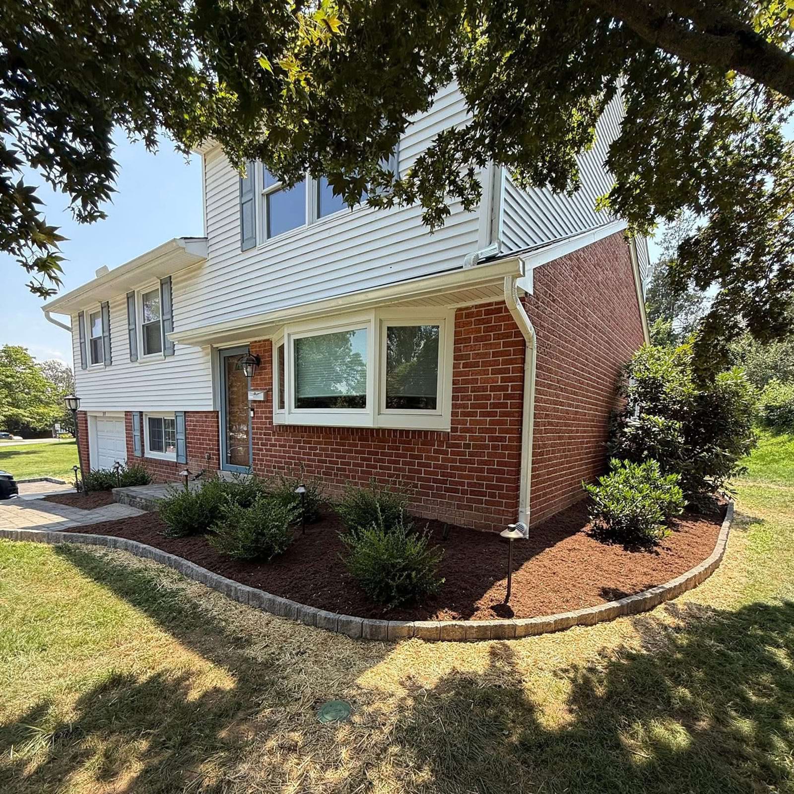 A mulch bed with new shrubs and freshly installed mulch for a clean and polished landscape in Wallingford, PA