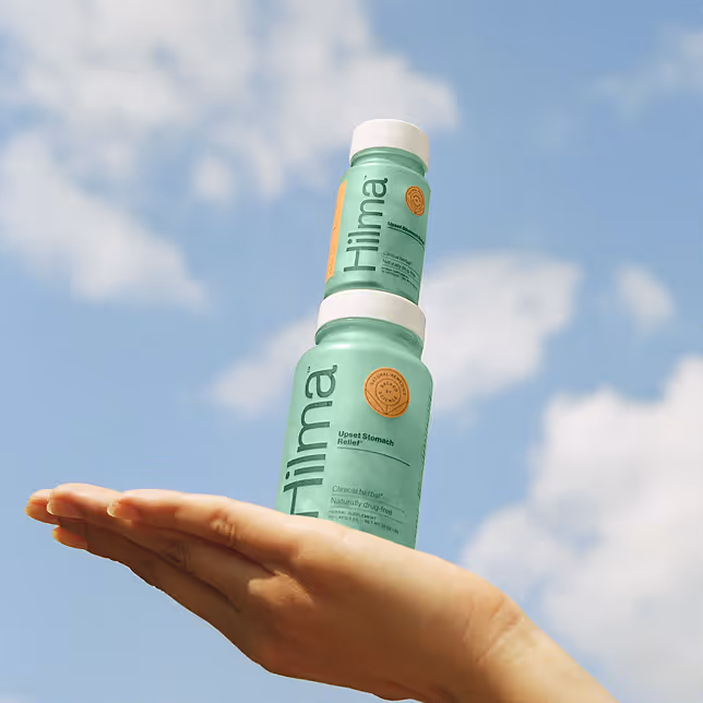 Person holding stacked medicine on similar blue cloudy sky aesthetic background like other ads