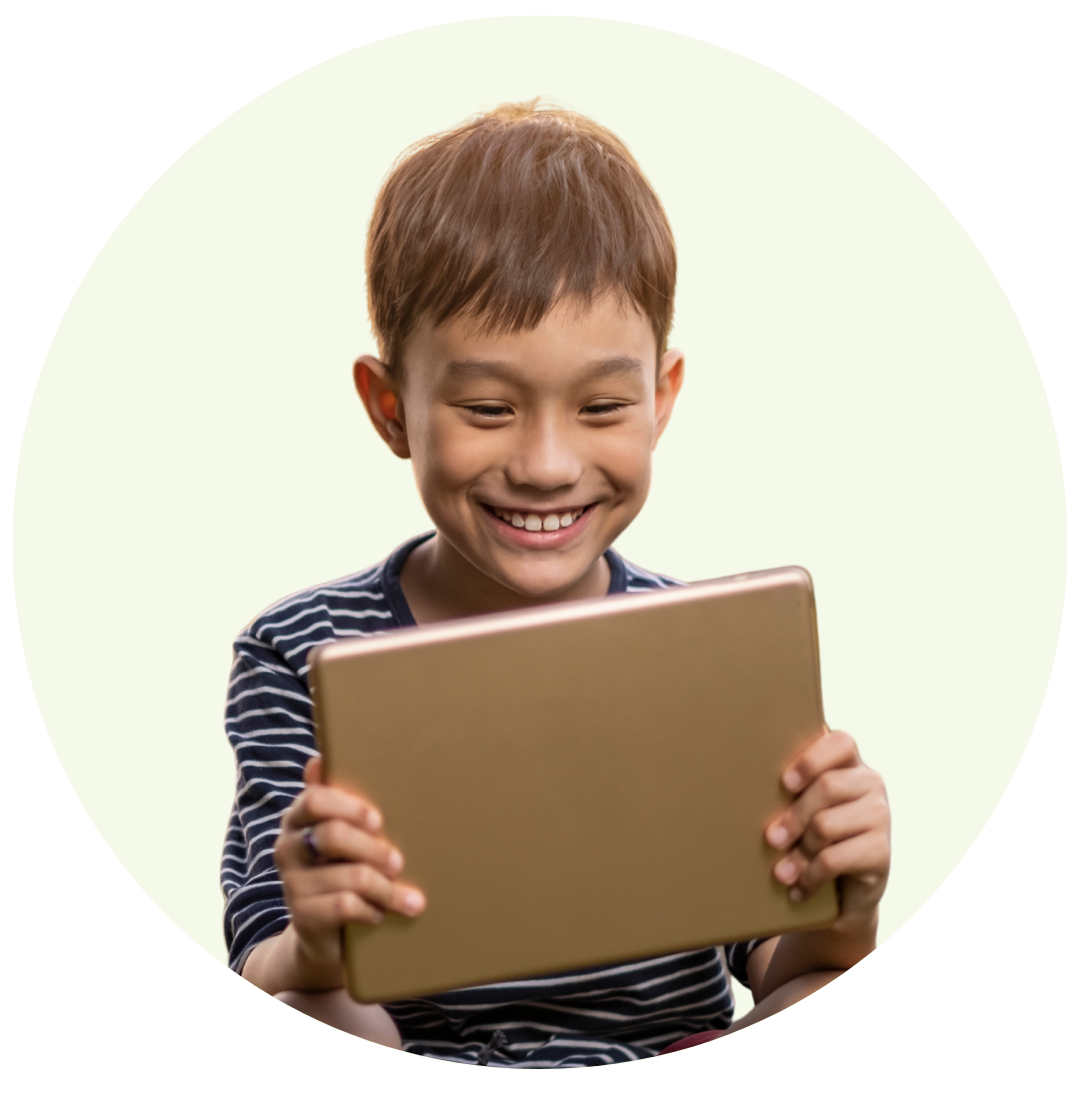 Smiling boy holding and looking at a gold tablet device.