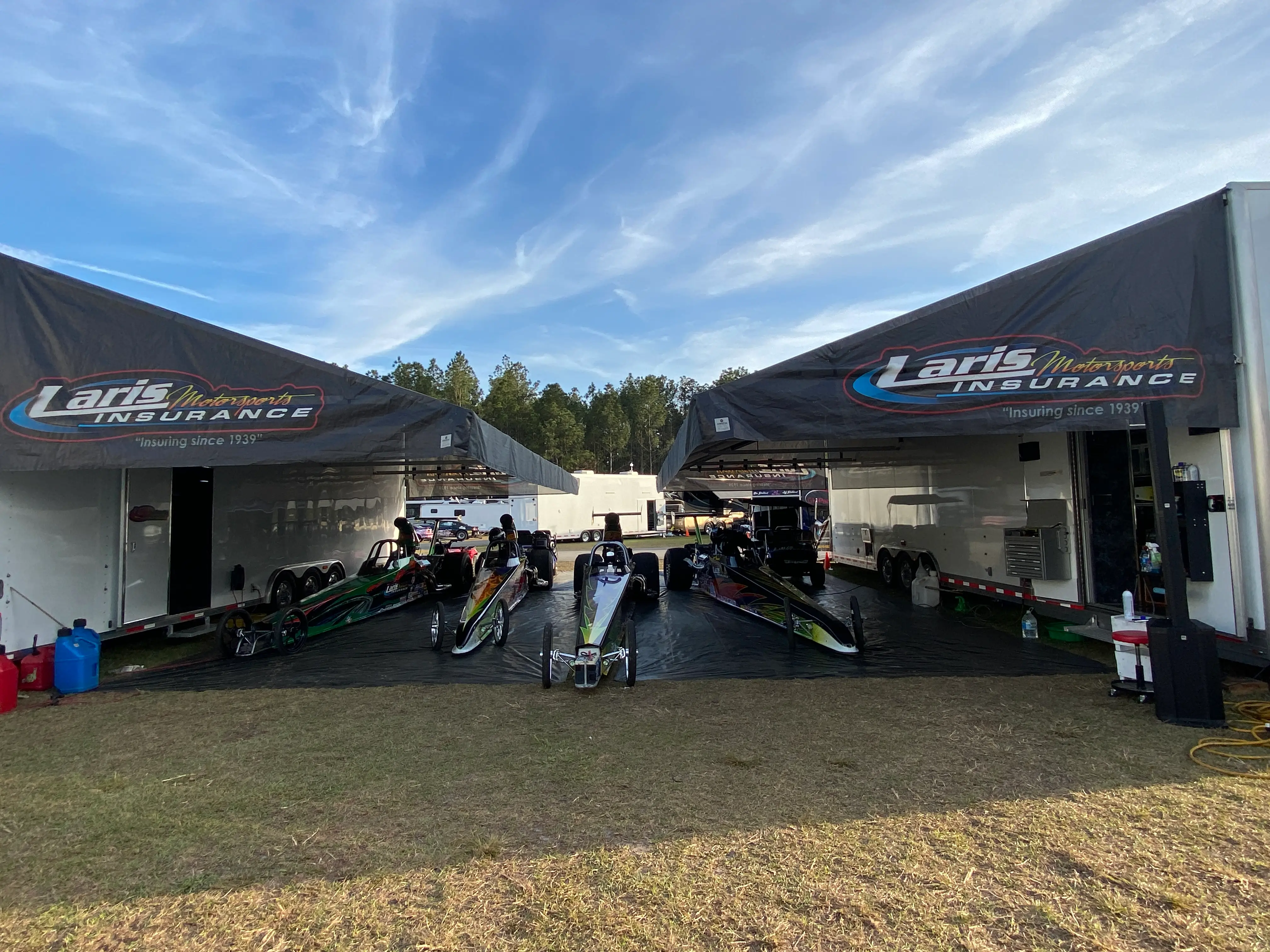 Top Fuel dragsters under tent
