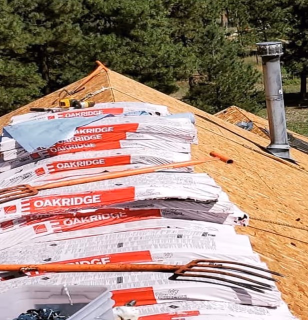 Oakridge asphalt shingles on a roof undergoing installation or repair.