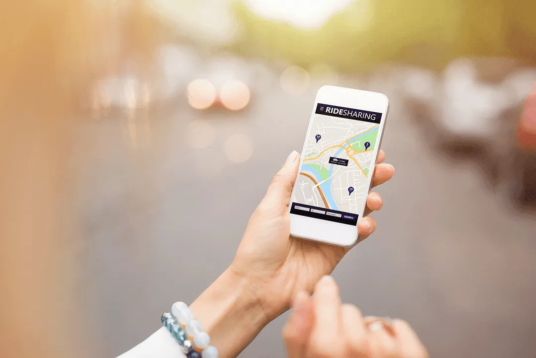 Person with a ridesharing app open on their phone.