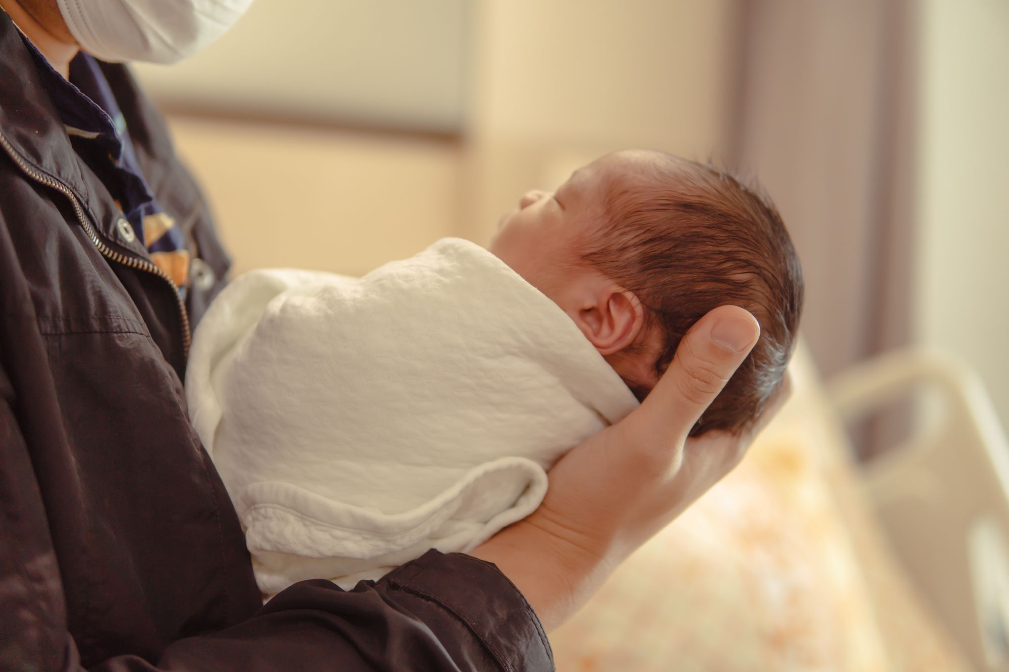 A newborn baby being cradled