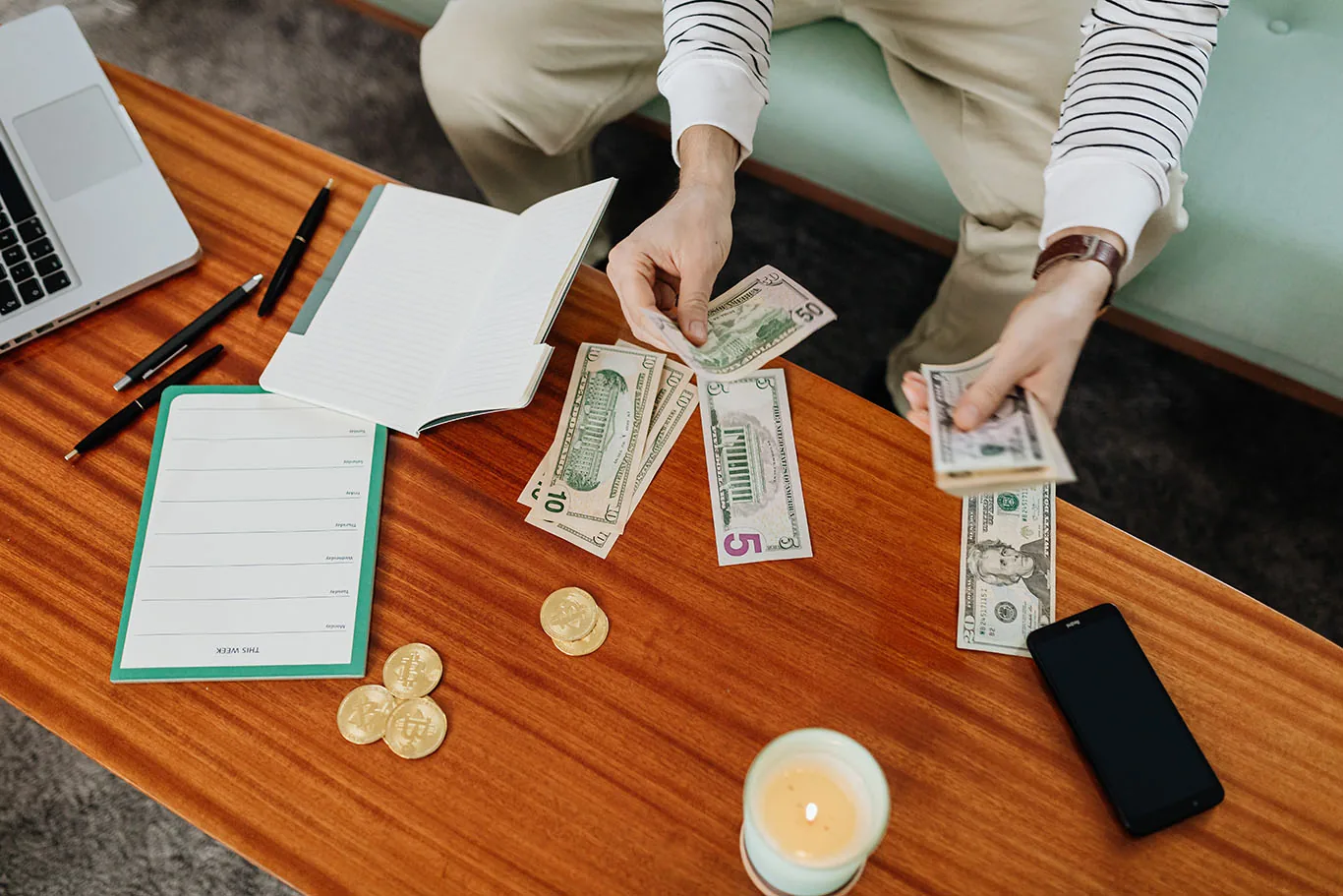 man counting money on table