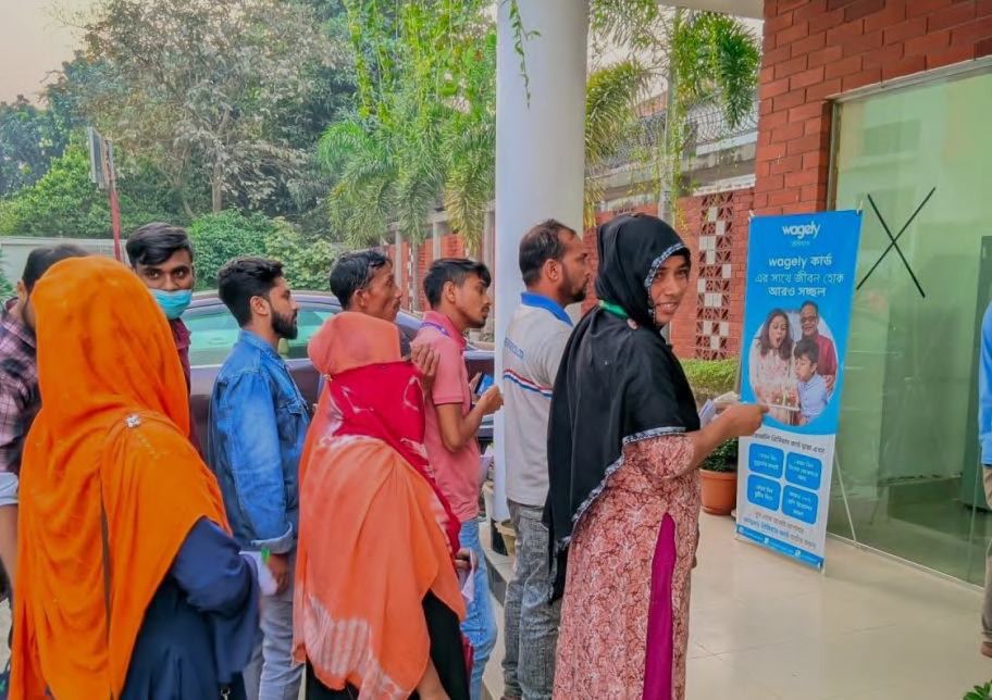 Workers lining up for earned wage access at a Wagely booth