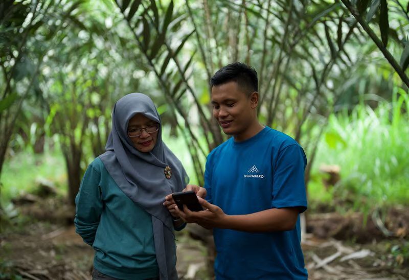 A smallholder farmer with her harvest in Indonesia
