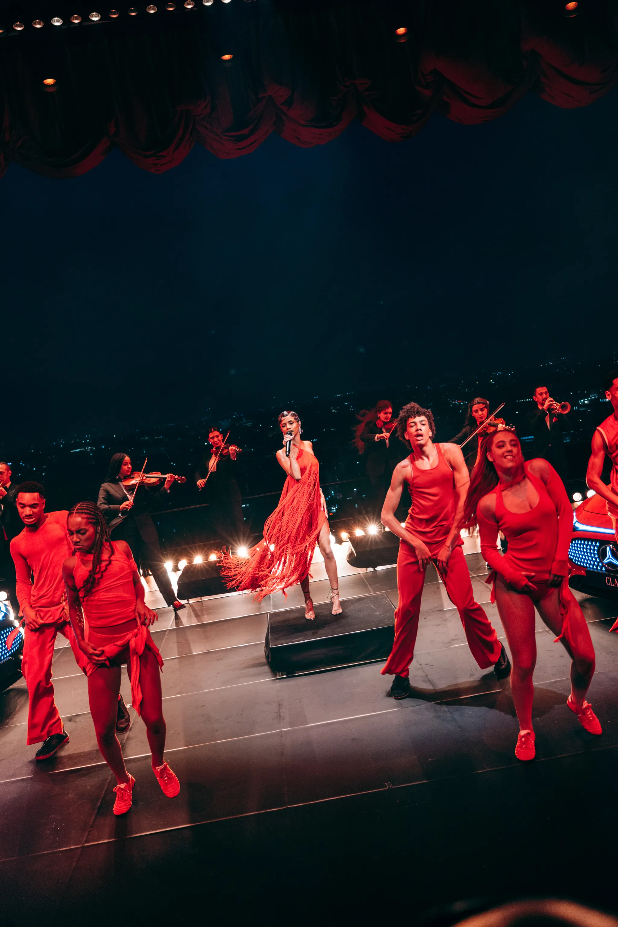 Dancers in red performing at the Mercedes-Benz CLA world premiere