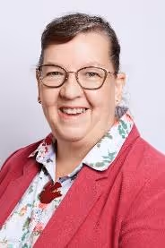 A person wearing glasses and a red jacketDescription automatically generated with low confidence