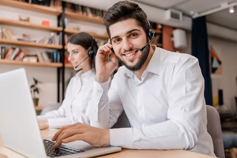 An IT recruiter in front of a laptop during a videocall.